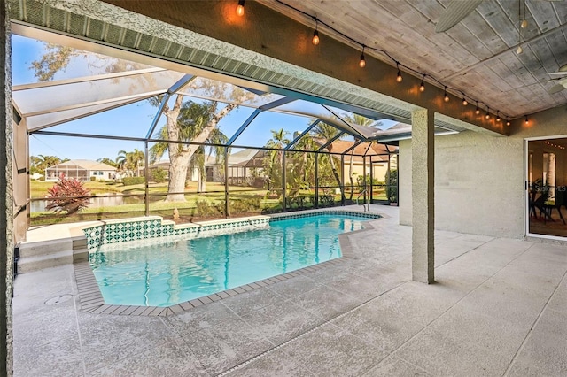 view of pool featuring glass enclosure and a patio area