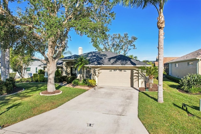 view of front of house featuring a garage and a front lawn