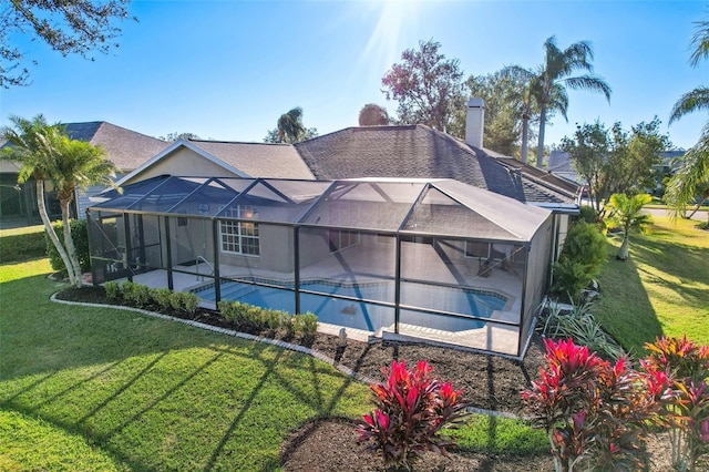 exterior space featuring a patio, glass enclosure, and a lawn