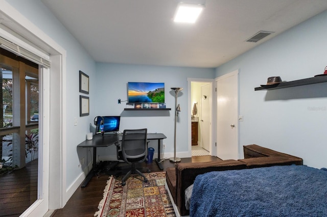 bedroom with dark hardwood / wood-style flooring