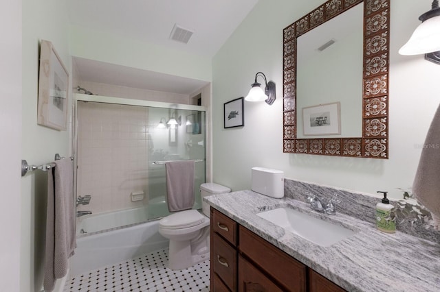 full bathroom with toilet, tile patterned floors, enclosed tub / shower combo, and vanity