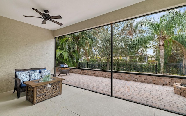 sunroom / solarium featuring ceiling fan