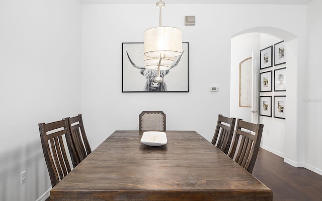 dining space with dark wood-type flooring