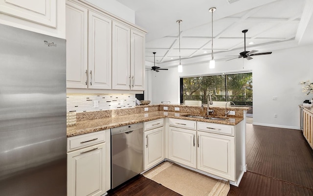 kitchen with coffered ceiling, kitchen peninsula, stainless steel appliances, light stone countertops, and sink