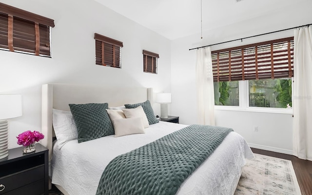 bedroom with dark hardwood / wood-style flooring