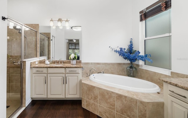 bathroom with vanity and independent shower and bath