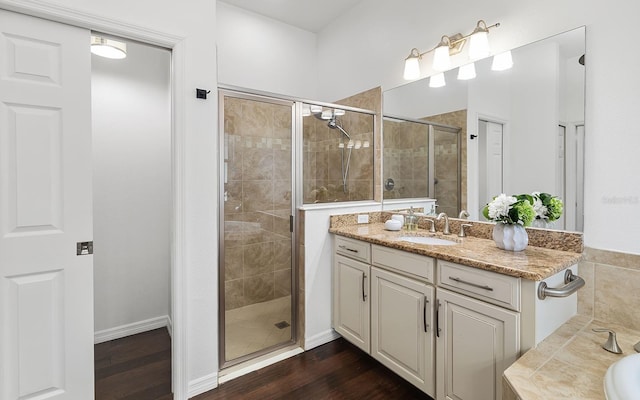 bathroom with vanity, independent shower and bath, and hardwood / wood-style floors