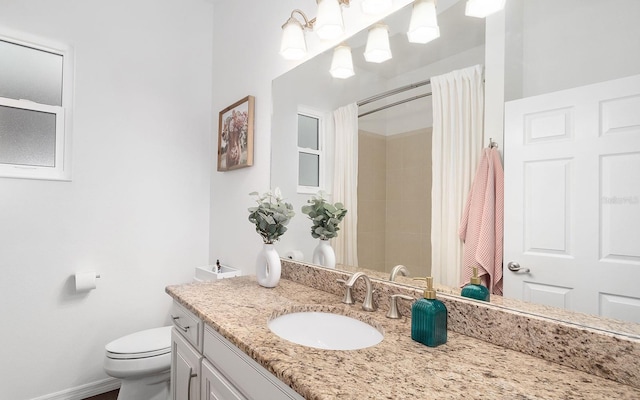 bathroom with toilet, a shower with shower curtain, and vanity