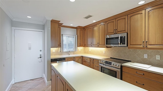 kitchen with sink, crown molding, appliances with stainless steel finishes, backsplash, and light tile patterned flooring