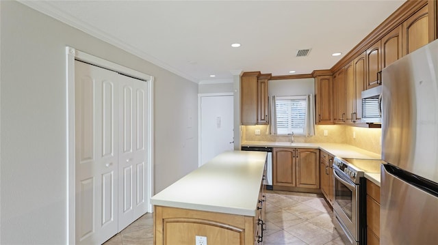 kitchen featuring a kitchen island, sink, decorative backsplash, stainless steel appliances, and crown molding