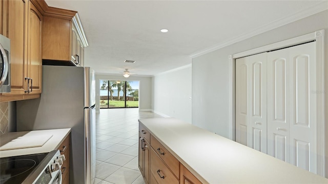 kitchen featuring light tile patterned floors, ornamental molding, ceiling fan, and appliances with stainless steel finishes