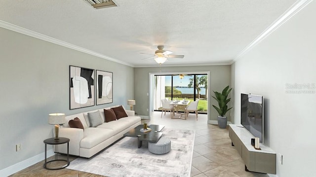 living room with light tile patterned flooring, ceiling fan, a textured ceiling, and crown molding