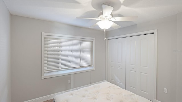 unfurnished bedroom featuring a closet and ceiling fan