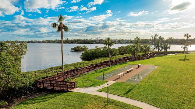 view of home's community featuring a lawn and a water view