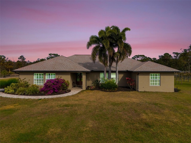 ranch-style home featuring a yard