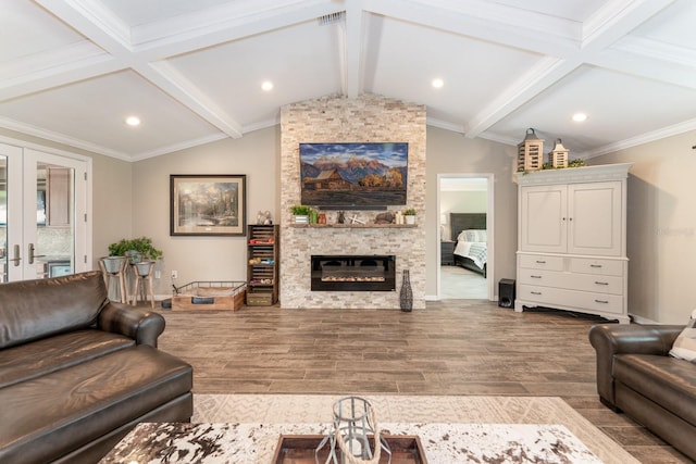 living room with french doors, crown molding, a stone fireplace, and lofted ceiling with beams