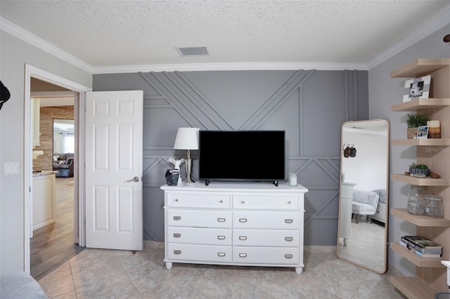 tiled bedroom featuring ornamental molding and a textured ceiling