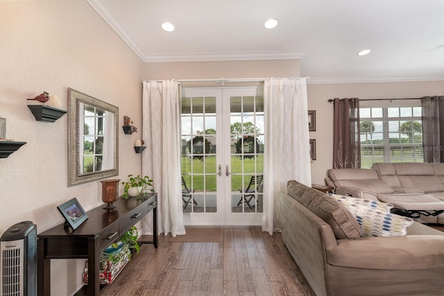 doorway featuring wood-type flooring, ornamental molding, and french doors