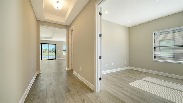 hallway featuring a raised ceiling