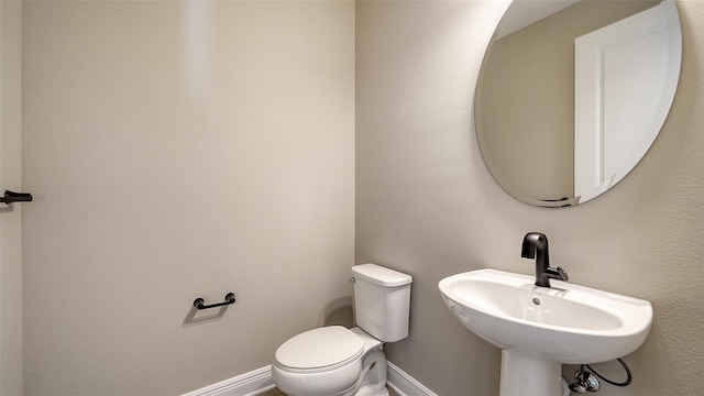 bathroom featuring toilet and sink