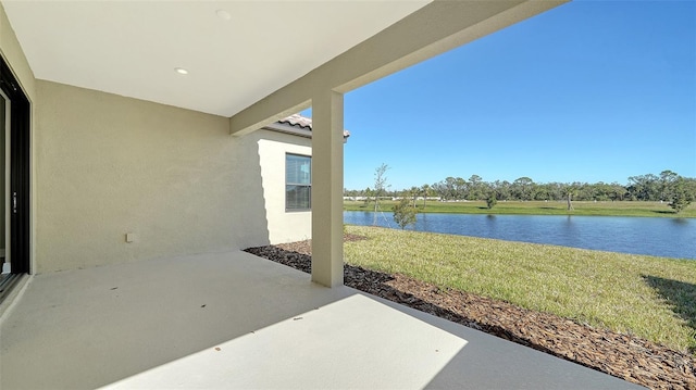 view of patio with a water view