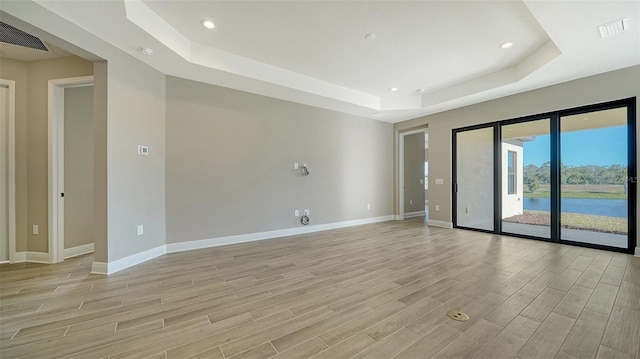 spare room featuring a tray ceiling