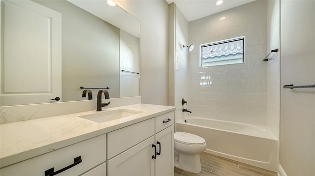 full bathroom featuring toilet, vanity, and bathing tub / shower combination