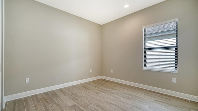 unfurnished room with light wood-type flooring