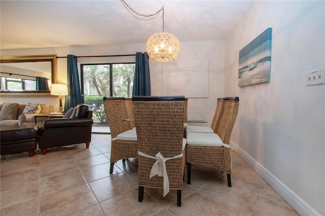 tiled dining room featuring a chandelier