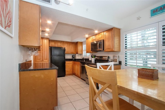 kitchen featuring appliances with stainless steel finishes, sink, and light tile patterned floors