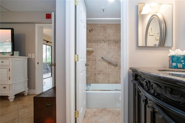 bathroom featuring vanity, tile patterned floors, and tiled shower / bath