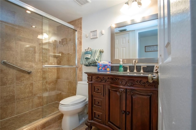 bathroom with vanity, an enclosed shower, and toilet