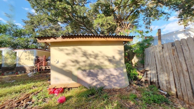 view of home's exterior with a storage shed