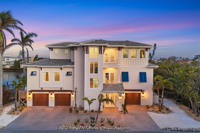 view of front facade featuring a garage and a balcony