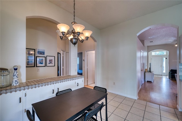 dining area featuring a notable chandelier and light tile patterned floors