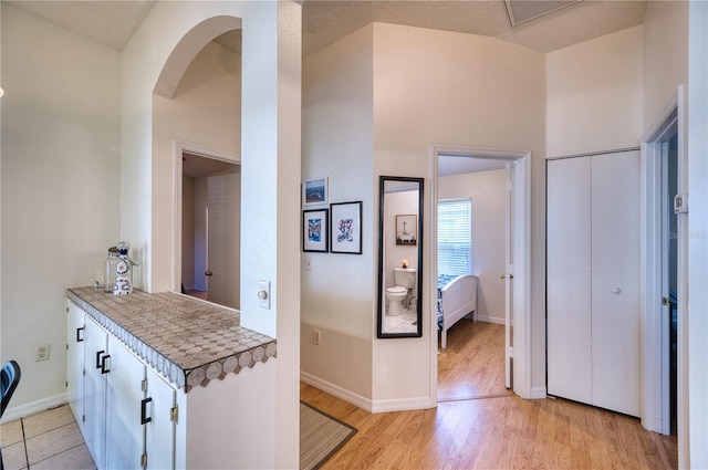 interior space with light hardwood / wood-style flooring and a textured ceiling