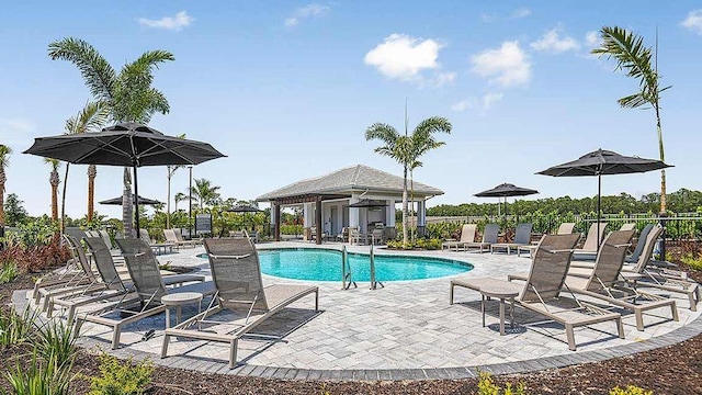 view of pool with a patio area and an outbuilding