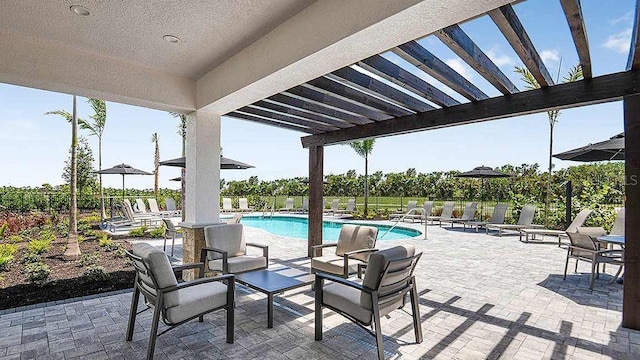 view of swimming pool featuring a pergola and a patio area