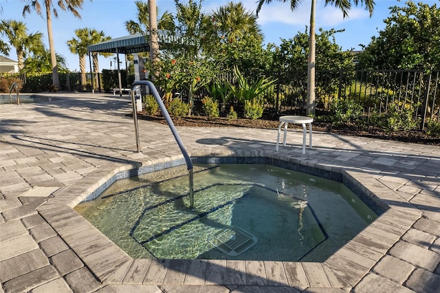 view of pool featuring a patio and an in ground hot tub