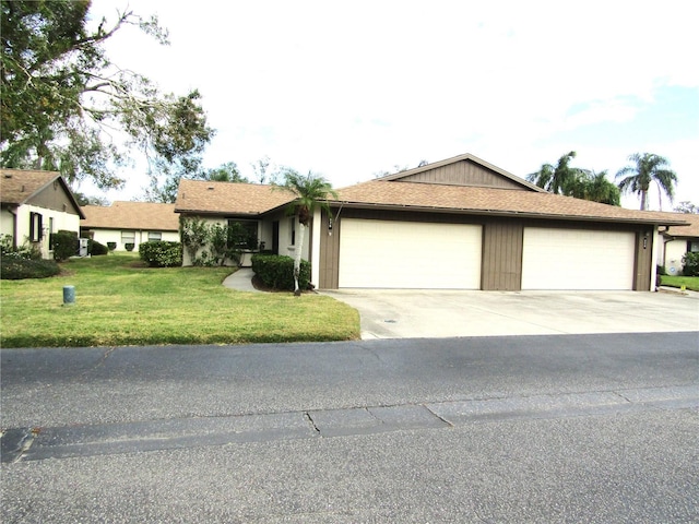 ranch-style home featuring a garage and a front yard