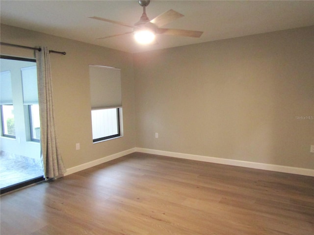 empty room featuring hardwood / wood-style floors and ceiling fan