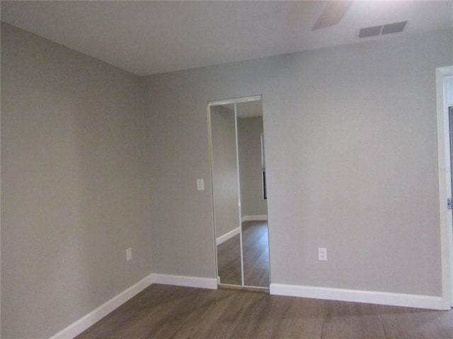 spare room with dark hardwood / wood-style floors