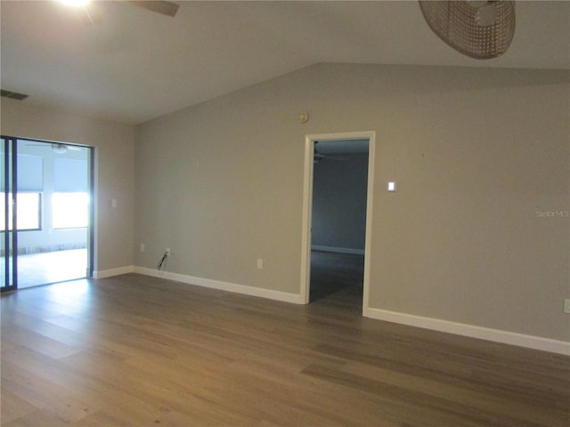 empty room with hardwood / wood-style flooring, vaulted ceiling, and ceiling fan