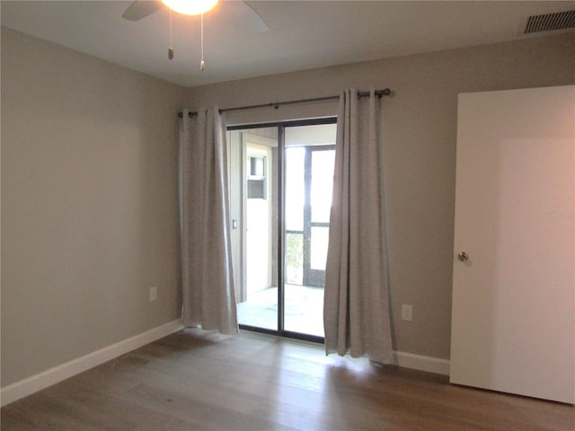 unfurnished room with ceiling fan and wood-type flooring