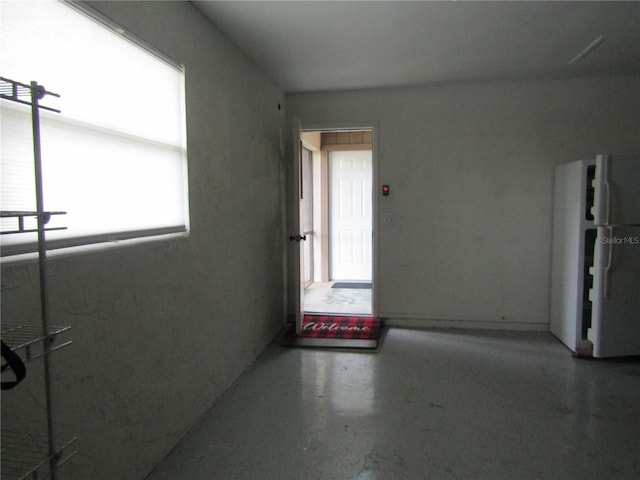 spare room with concrete flooring