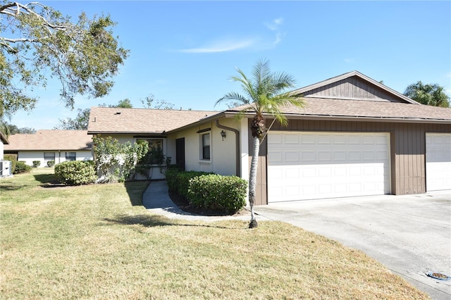 single story home with a garage and a front lawn