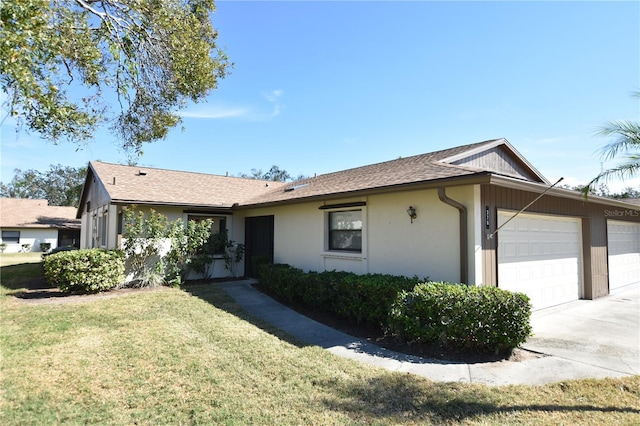 single story home featuring a garage and a front yard