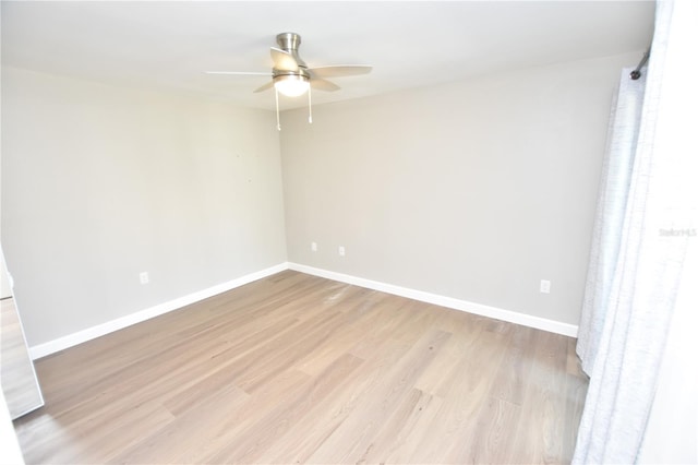 empty room with light hardwood / wood-style flooring and ceiling fan