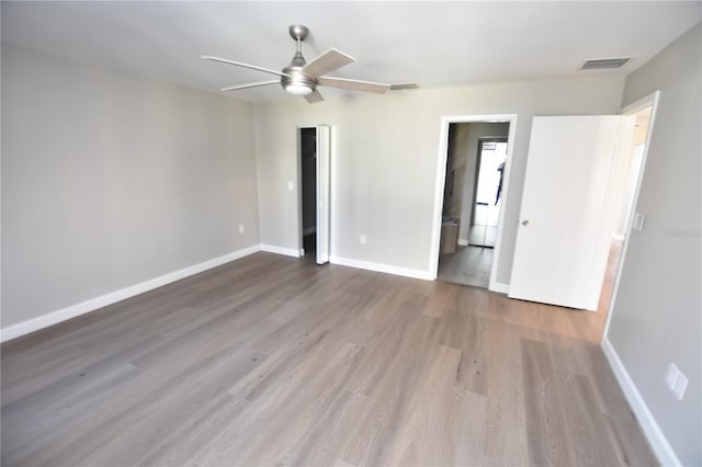 spare room with ceiling fan and light hardwood / wood-style floors