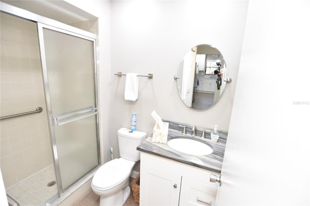 bathroom with vanity, toilet, and an enclosed shower